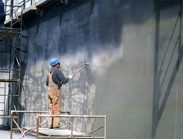 Crystalline waterproofing coating applied to concrete